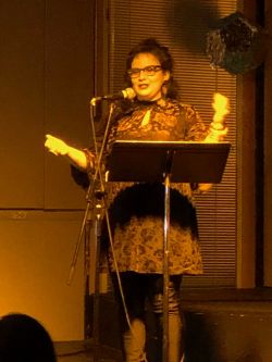 Photo of Dorothea Laskey reading during Little Corner Presents: Excess Women