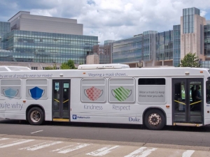 Six campus buses feature images of masks and messages that encourage people to wear a mask to protect everyone. Photo courtesy of Duke Health Marketing & Communications.