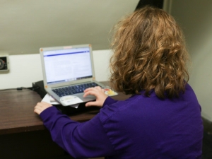 Photo of an individual working on an laptop