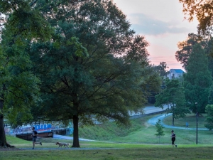 People go on a run on campus in May of 2019. A mask/face covering is now required on the East Campus and Al Buehler trails. Photo by Jared Lazarus, Duke University Communications.