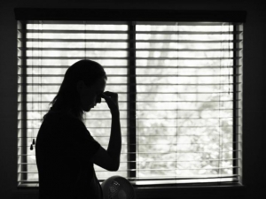 Silhouette of person in front of a window.  IStock.com/KIerferPix