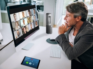 Video meetings with multiple people require more attention to focus on facial expressions and cues than in-person conversations and come with distractions such as noise and virtual background visuals. Photo courtesy of Zoom.