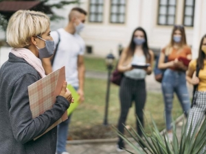 Photo of masked instructor and student outdoors VLADIMIR VLADIMIROV VIA GETTY IMAGES