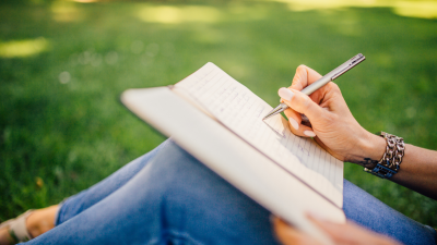 Image of writer setting in grass